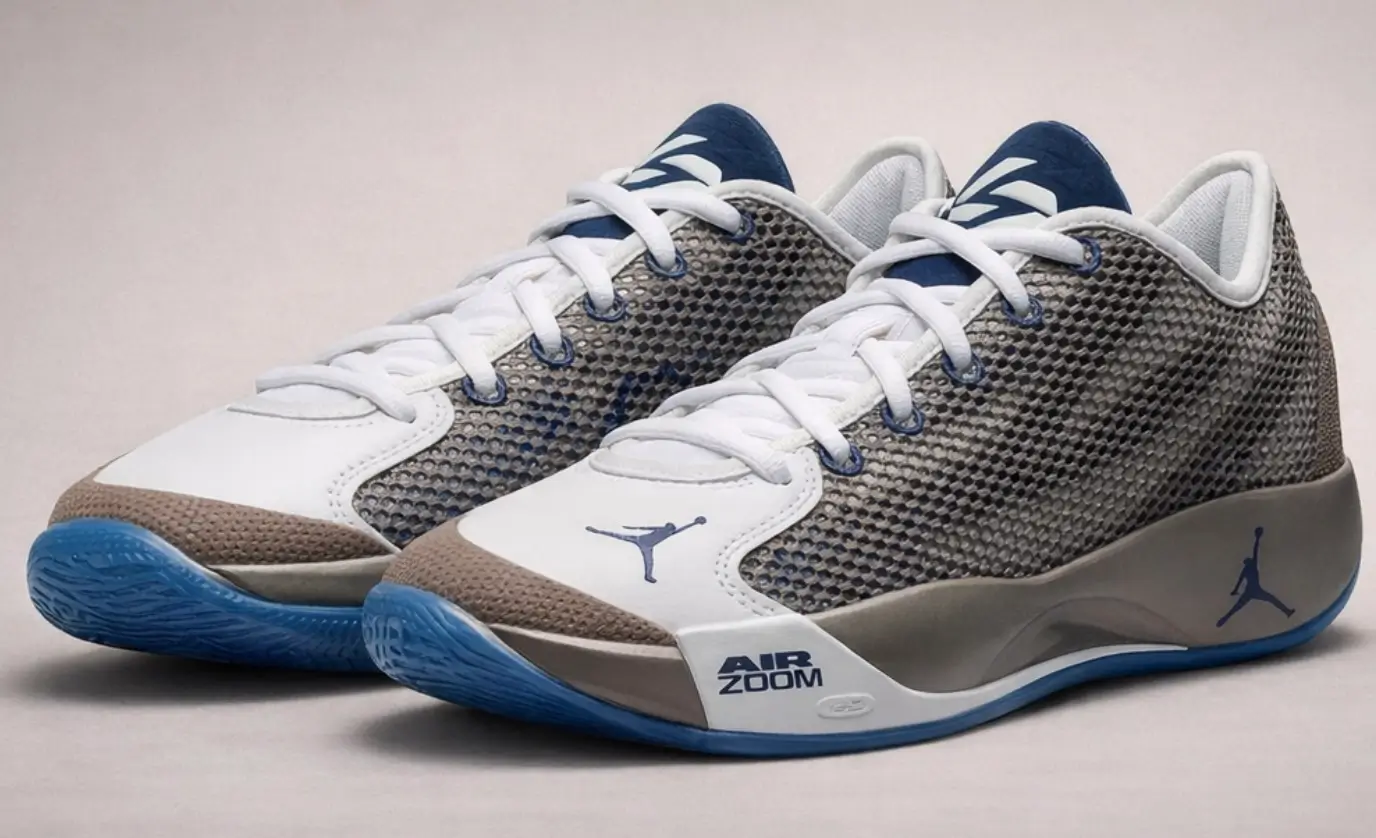 Angled side view of the Jordan Luka .77 “Olive Grey” showing layered olive-grey mesh upper, white leather forefoot panel with Jumpman logo, sculpted burgundy-toned midsole with Air Zoom branding, and translucent blue outsole