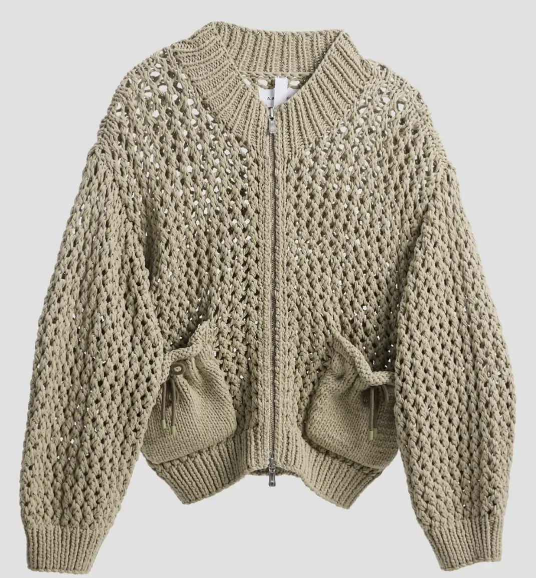 YUJI ZIP-UP CARDIGAN in a neutral tone featuring oversized big gauge lace knit construction, a boxy silhouette, ribbed collar and hem, metallic front zipper, and two front pouch-style pockets with drawstring detailing