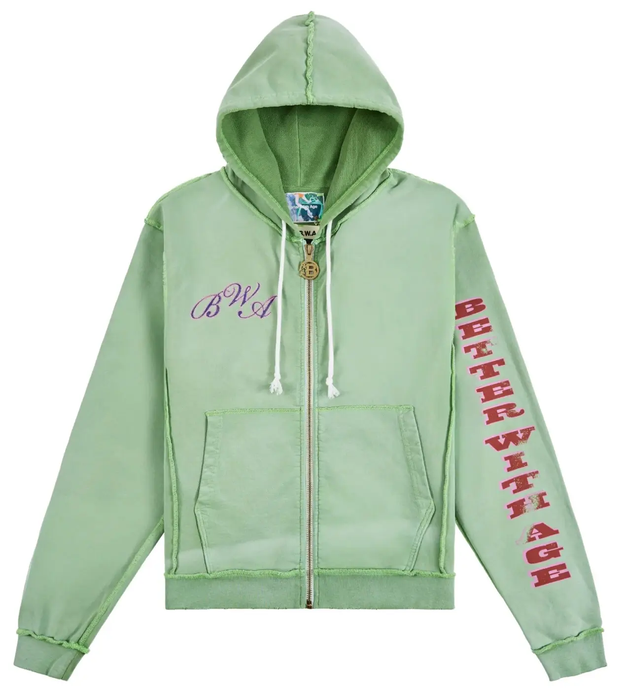 Front view of Better With Age Magic Zip-Up Hoodie in washed green featuring purple BWA chest embroidery, distressed “Better With Age” sleeve print, exposed seam construction, white drawstrings, and gold zip closure