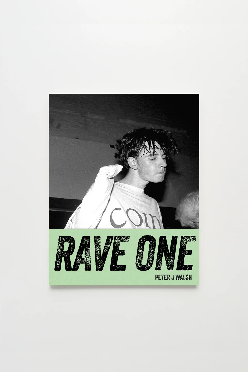 Black-and-white cover of Rave One by Peter J Walsh featuring a sweat-soaked clubgoer in profile at Manchester’s Haçienda, with bold distressed title text on a pale green band below