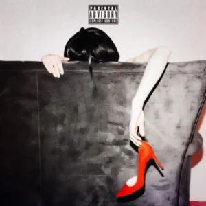 Figure behind couch gripping red heel shoe under parental advisory label