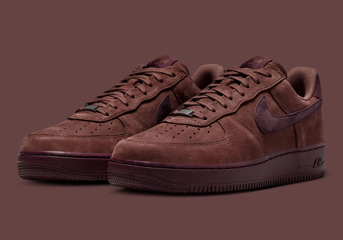 Pair of Nike Air Force 1 Low Premium “Red Sepia” sneakers in angled view with tonal brown leather and mahogany Swoosh
