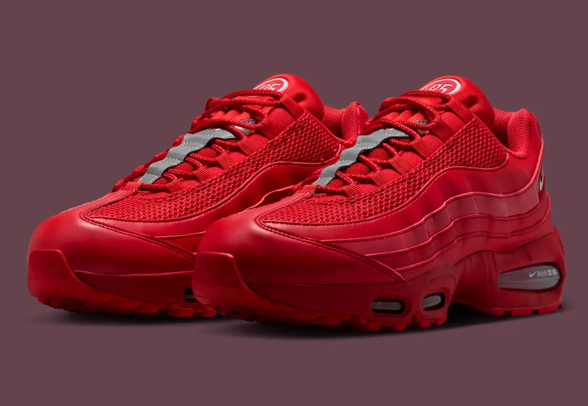 Angled side view of Nike Air Max 95 Total 90 “University Red” showing full red gradient upper, layered side panels, mesh texture, and visible Air cushioning with subtle black accents